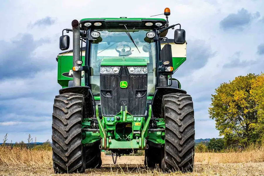 John Deere tractor on a field with large agricultural tyres