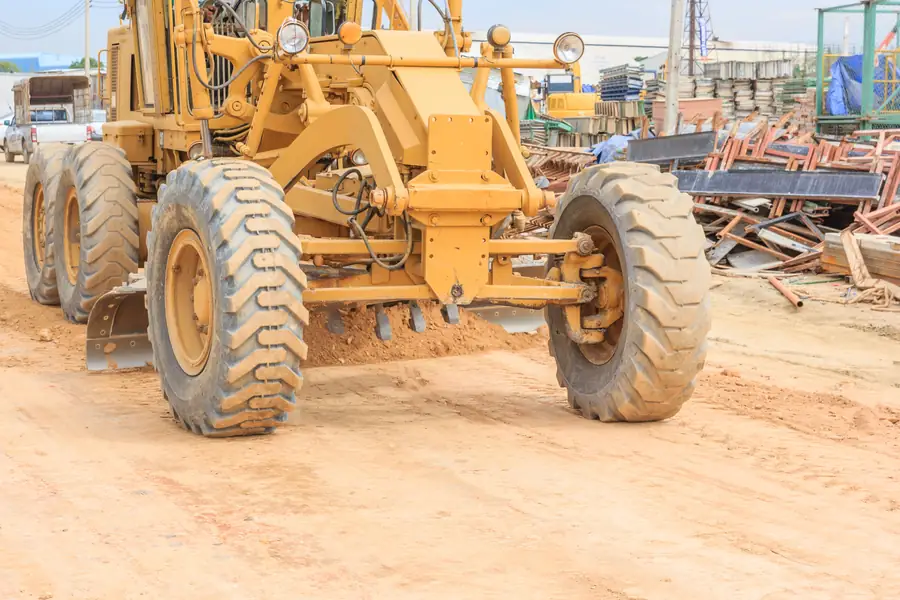 Motor grader working on a road construction site