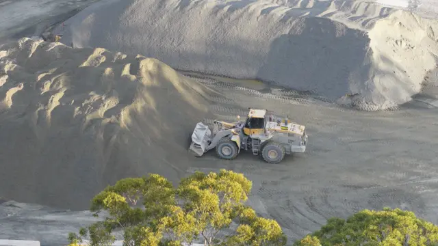 Wheel loader moving earth at a quarry, seen from above