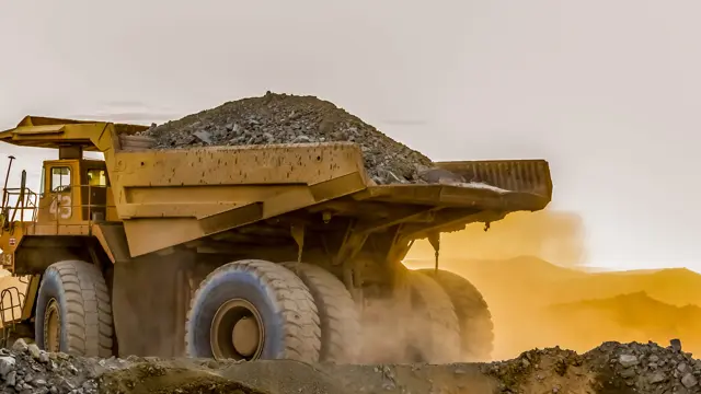 Large dump truck carrying a load of sand at a mining site in Africa