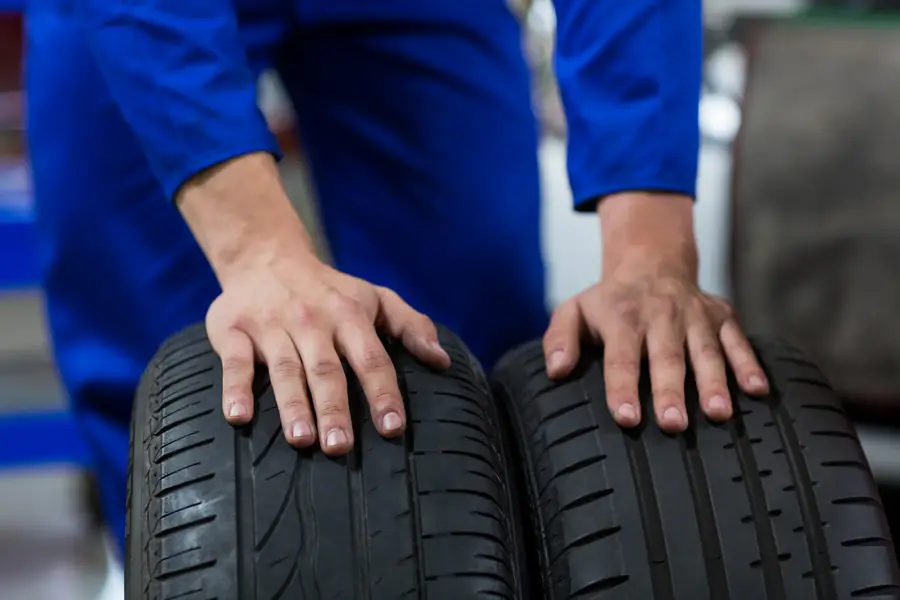 Mechanic checking a new tyre before fitment